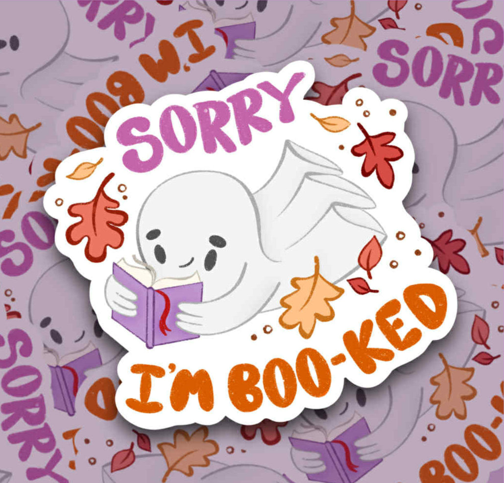 Sticker with a ghost holding a book and text 'Sorry I'm Boo-ked' on a patterned background.